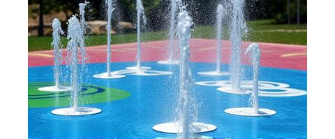 Ground sprayers in a splash pad